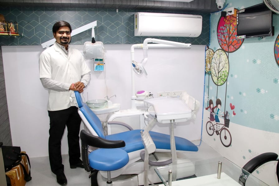 Dr Devendrapratap Singh in front of his dental chair